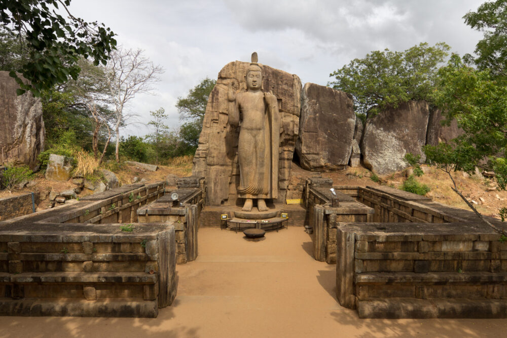 Photo of The Avukana Buddha statue, a 12-metre-tall (39 ft) standing Buddha statue from the reign of Dhatusena of Anuradhapura, 5th century.