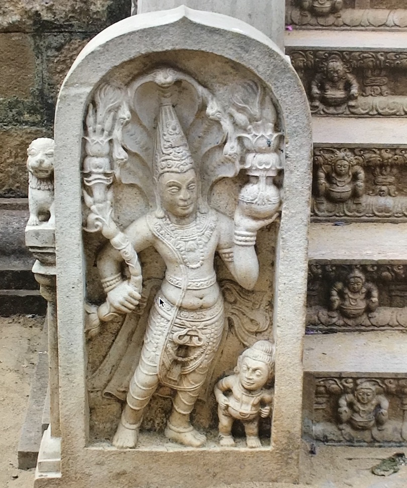 Guardstone on steps to Sri Maha Bodhi Tree in Anuradhapurs, Sri Lanka. Note yaksha at base of stone and more on risers supporting steps. A naga flares over guardian as hood.