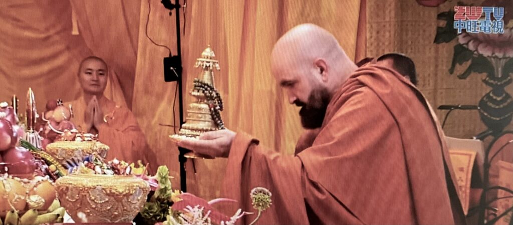 Photo of Holy Guru Mozhi presenting his offering at the 2026 Dharma Assembly honoring the Holy Birthday of Namo Dorje Chang Buddha III. 