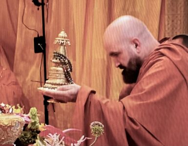 Photo of Holy Guru Mozhi presenting his offering at the 2026 Dharma Assembly honoring the Holy Birthday of Namo Dorje Chang Buddha III.