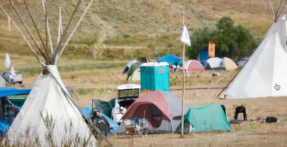 Buddhist camp in back near trees with orange TIbetan door.