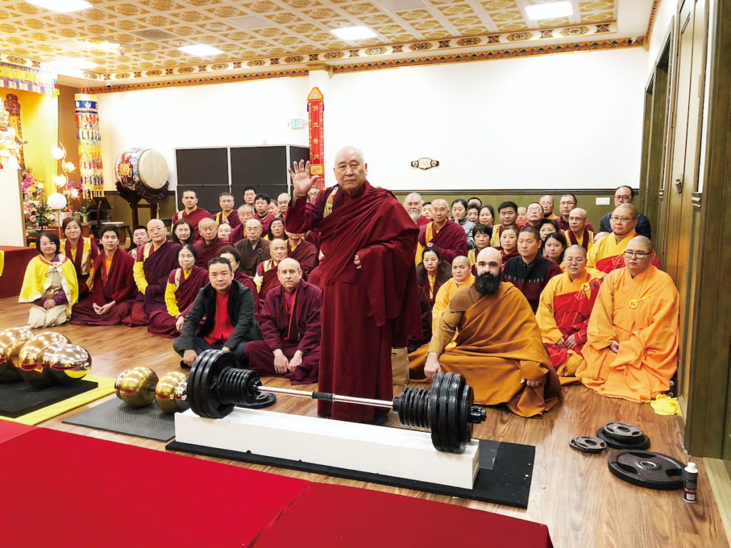 Elderly Holy Guru Kaichu Jiaozun who is almost 90 years old lifted a 200-pound Vajra Pestle from the ground and held it for seven seconds before placing it onto the Platform.