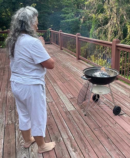 Photo of Anjurshri burning her precious journals as instructed. 