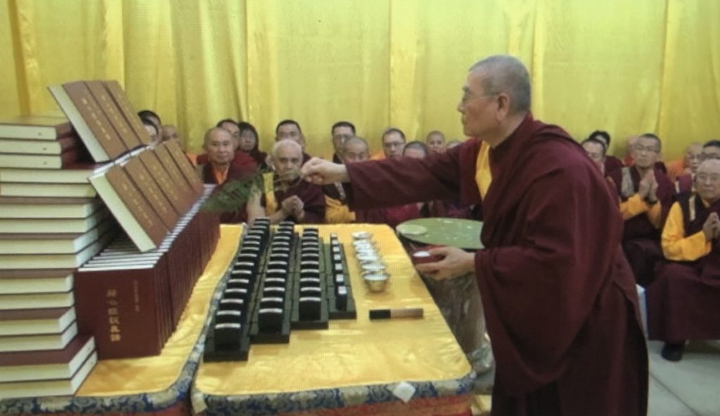 Dharma King Gar Tongstan is using the Seven-Component Holy water to empower the stamping seals and ink paste to be used for the first-publishing memorial edition of "Expounding the Absolute Truth through the Heart Sutra."