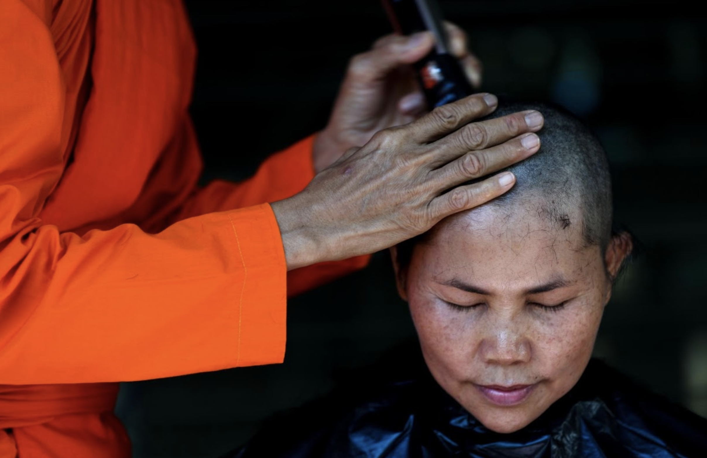 Young Thai woman having her head shaved