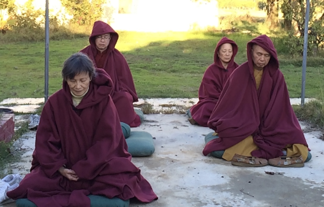 Pilgrims meditating with the Holy Vajra Poles.